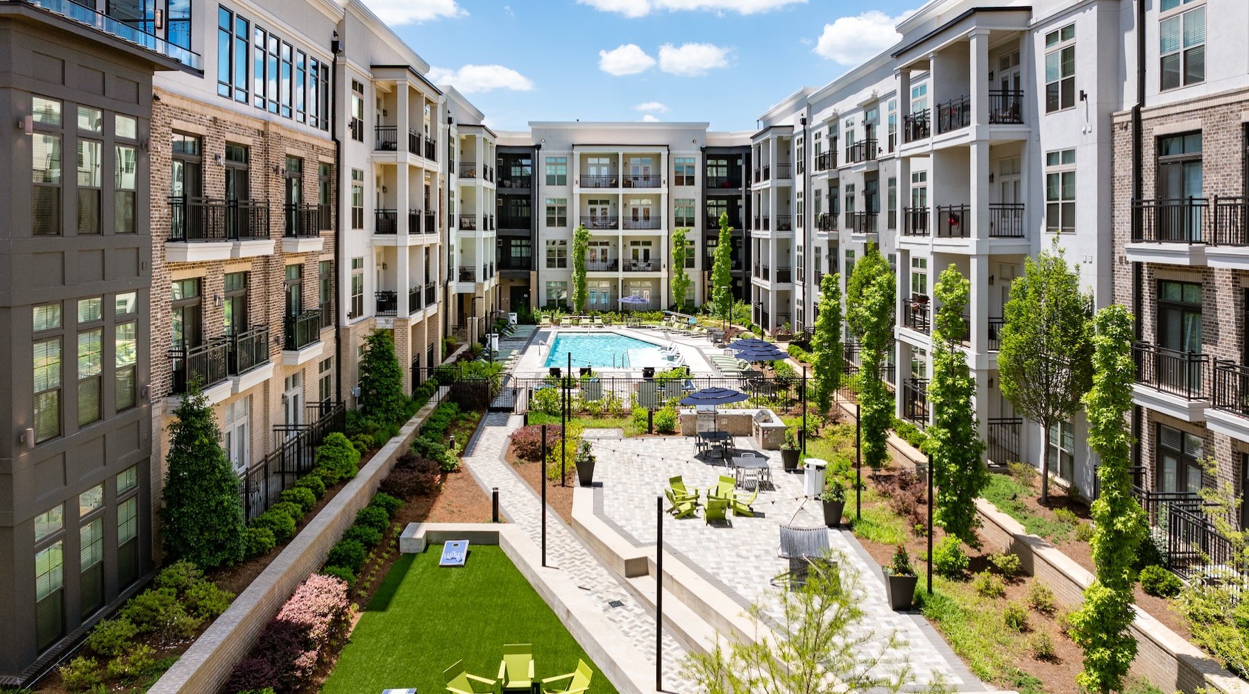 aerial view of a pool and outdoor seating in a courtyard