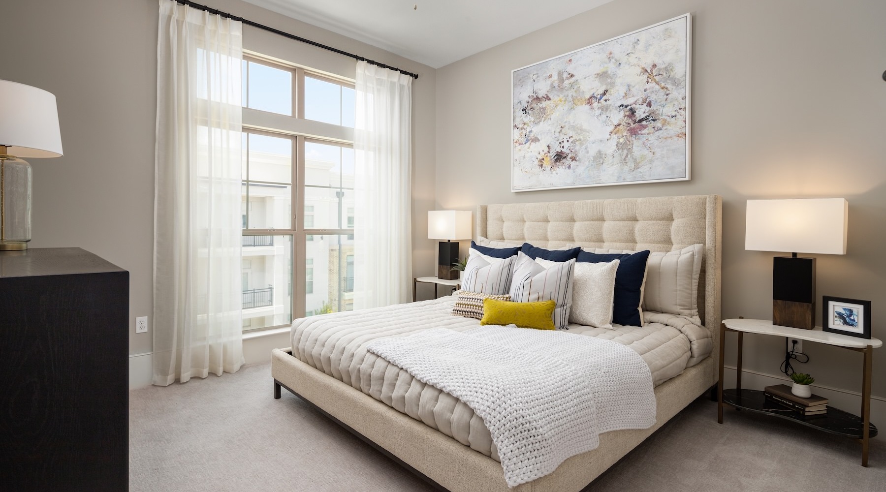 bedroom with tables lamps window and ceiling fan