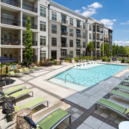 outdoor swimming pool surrounded by lounge chairs